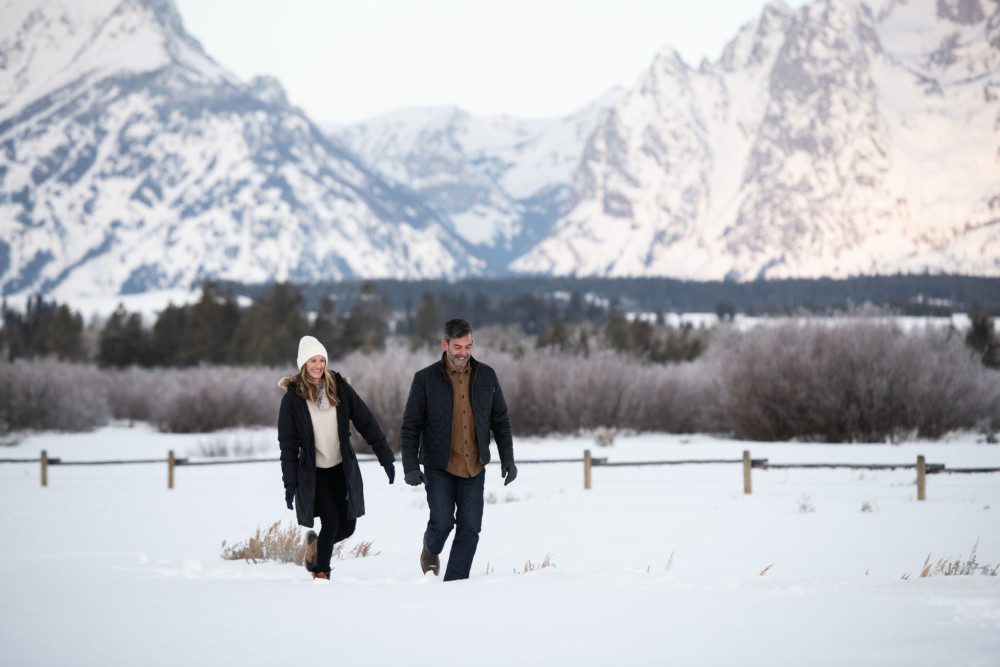 Couple Walking In Winter In The Tetons.