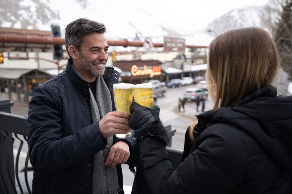 A couple enjoying a beer on The Town Square.