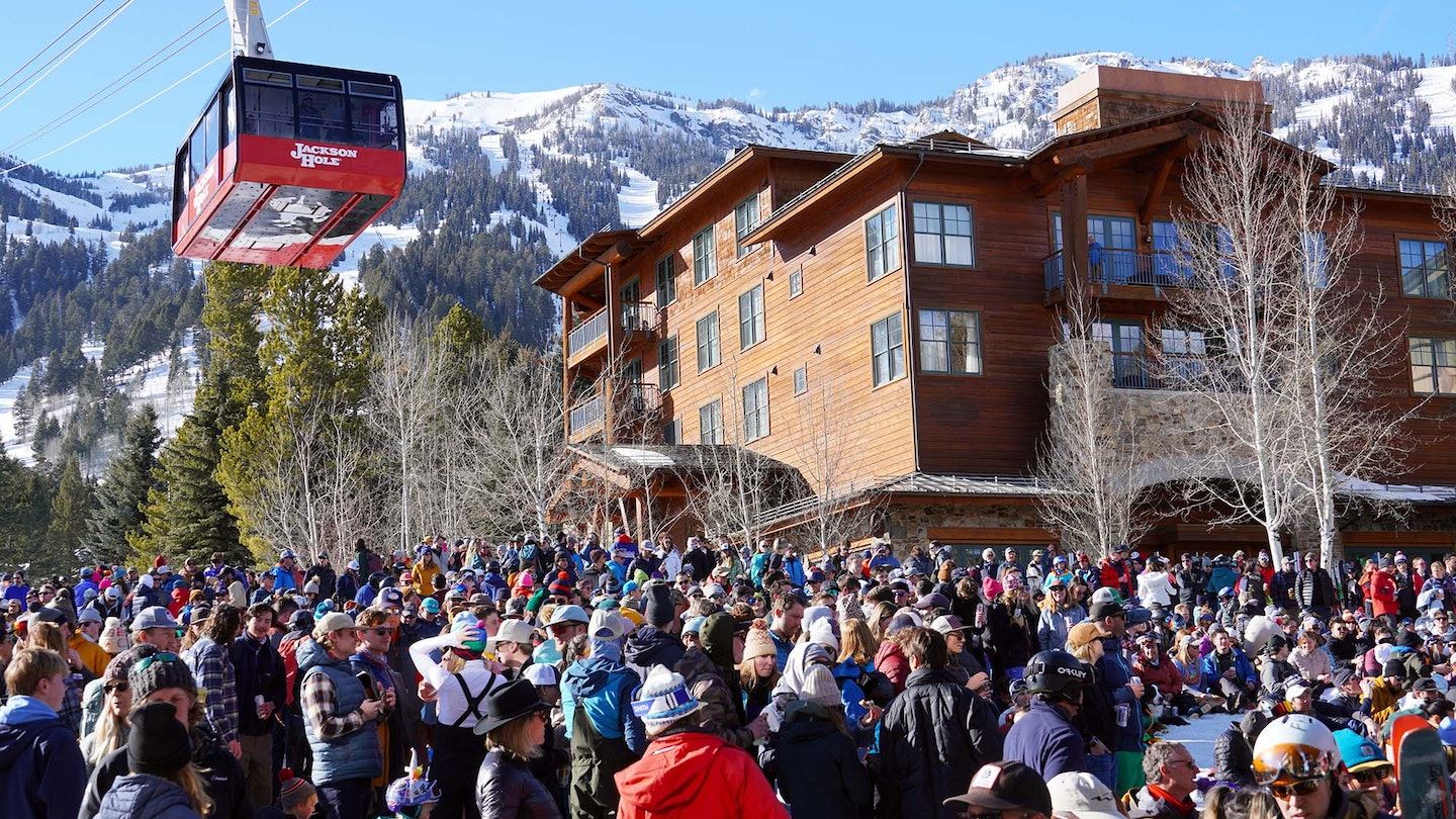 A crowd of people standing below the tram at Jackson Hole Mountain Resort.